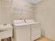 Functional laundry room with washer, dryer, sink, and wire shelving for storage at 2320 Starr Lake Nw Dr, Acworth, GA 30101