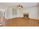 Comfortable living area featuring hardwood floors, a brick fireplace, and built-in shelving at 2320 Starr Lake Nw Dr, Acworth, GA 30101