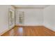 Spacious living room with a door to the backyard, neutral walls, and wood flooring at 2320 Starr Lake Nw Dr, Acworth, GA 30101