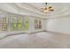 Large main bedroom with tray ceilings, a ceiling fan, neutral carpet and ample natural light at 2320 Starr Lake Nw Dr, Acworth, GA 30101