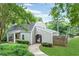 Exterior view of a home with lush green landscaping, a walkway, and a well-maintained lawn at 2794 Farmstead Se Rd, Smyrna, GA 30080