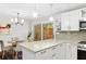 Modern kitchen featuring granite counters, stainless appliances and adjacent dining area at 2794 Farmstead Se Rd, Smyrna, GA 30080