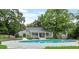 Community pool surrounded by lush greenery, with a clubhouse and ample space for lounging at 2794 Farmstead Se Rd, Smyrna, GA 30080