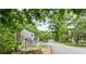 The tree-lined street view shows the community entrance sign at Farmstead at Vinings at 2794 Farmstead Se Rd, Smyrna, GA 30080