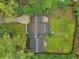 Aerial view of the home showcasing the roof, backyard, driveway, landscaping, and surrounding trees at 3356 Thornewood Dr, Atlanta, GA 30340