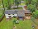 A backyard aerial view features a roof with skylights, a covered porch, and a fire pit surrounded by lush landscaping at 3356 Thornewood Dr, Atlanta, GA 30340