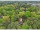 A charming home nestled in a dense green tree canopy, offering a private retreat surrounded by lush natural beauty at 3356 Thornewood Dr, Atlanta, GA 30340