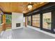 Inviting back porch featuring a fan, fireplace and sliding glass doors at 3356 Thornewood Dr, Atlanta, GA 30340