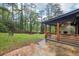 Expansive backyard featuring a covered porch with a fireplace and a charming fire pit area at 3356 Thornewood Dr, Atlanta, GA 30340