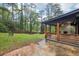 Backyard features a cozy covered porch, fire pit, and wood privacy fence at 3356 Thornewood Dr, Atlanta, GA 30340