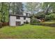 Spacious backyard featuring lush greenery, wooden fence and covered porch at 3356 Thornewood Dr, Atlanta, GA 30340