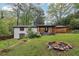 Spacious backyard featuring a fire pit and ample green space, perfect for outdoor enjoyment at 3356 Thornewood Dr, Atlanta, GA 30340