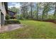 Large backyard, features grass, a patio, and a view of the home's unique outdoor living spaces at 3356 Thornewood Dr, Atlanta, GA 30340