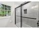 Modern bath features white marble, black fixtures, and glass enclosed shower at 3356 Thornewood Dr, Atlanta, GA 30340