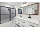 Modern bathroom featuring a double sink vanity with white cabinets, marble floor tiles, and a shower-tub combination at 3356 Thornewood Dr, Atlanta, GA 30340