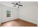 Cozy bedroom with wood floors, ceiling fan, and a window letting in natural light at 3356 Thornewood Dr, Atlanta, GA 30340