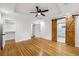 Bright bedroom with hardwood floors, ceiling fan, barn door to bathroom, and walk-in closet at 3356 Thornewood Dr, Atlanta, GA 30340
