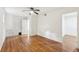 Bedroom features a brick wall, hardwood floors, white trim and doors, and a ceiling fan at 3356 Thornewood Dr, Atlanta, GA 30340