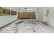 Carport with concrete flooring, access to the backyard through a wood gate, and white painted brick walls at 3356 Thornewood Dr, Atlanta, GA 30340