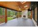 Spacious covered deck with a ceiling fan, fireplace, skylights and views of the private, wooded backyard at 3356 Thornewood Dr, Atlanta, GA 30340