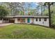 Charming single-story home featuring a blue door, white brick, a carport and a well-manicured lawn at 3356 Thornewood Dr, Atlanta, GA 30340