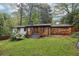 Charming home exterior featuring a manicured lawn, carport, and freshly painted white brick at 3356 Thornewood Dr, Atlanta, GA 30340