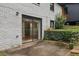 Back exterior of home features brick, sliding glass doors to the interior, and greenery at 3356 Thornewood Dr, Atlanta, GA 30340