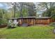 Well-maintained backyard with driveway and white painted brick home at 3356 Thornewood Dr, Atlanta, GA 30340