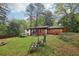 Landscaped backyard with fire pit, seating, and a covered porch at 3356 Thornewood Dr, Atlanta, GA 30340