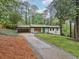 Well-maintained single-story home with a carport, long driveway, and beautiful landscaping at 3356 Thornewood Dr, Atlanta, GA 30340