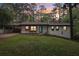 Beautiful one story home featuring a carport, lush green lawn and a modern design at 3356 Thornewood Dr, Atlanta, GA 30340