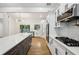 Modern kitchen with gray island, stainless appliances, and gas cooktop at 3356 Thornewood Dr, Atlanta, GA 30340