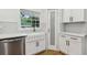 Close up on the kitchen sink with white cabinets and quartz counters at 3356 Thornewood Dr, Atlanta, GA 30340