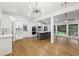 Bright, open kitchen featuring white cabinets, stainless steel appliances, large island, and hardwood floors at 3356 Thornewood Dr, Atlanta, GA 30340