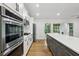 Modern kitchen featuring stainless steel appliances and a large center island, perfect for cooking and entertaining at 3356 Thornewood Dr, Atlanta, GA 30340