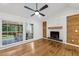Picture windows offer views to the covered porch, and a white brick fireplace complements the hardwood floors at 3356 Thornewood Dr, Atlanta, GA 30340