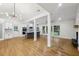 Open-concept living and kitchen area with hardwood floors, fireplace, and plenty of natural light at 3356 Thornewood Dr, Atlanta, GA 30340
