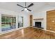 Living room showcasing a wood burning fireplace, hardwood floors, and large windows overlooking the backyard at 3356 Thornewood Dr, Atlanta, GA 30340