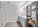 Bright bathroom featuring a double vanity, a glass enclosed shower, and a gray wood storage rack at 6179 Centennial Run, Atlanta, GA 30349