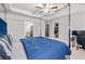 Bedroom featuring a walk in closet, ensuite bathroom, tray ceilings and a metal frame bed at 6179 Centennial Run, Atlanta, GA 30349