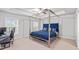 Spacious bedroom featuring a metal frame bed and a tray ceiling with a ceiling fan at 6179 Centennial Run, Atlanta, GA 30349