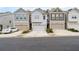 Street view of lovely townhomes with attached one-car garages and driveway at 6179 Centennial Run, Atlanta, GA 30349