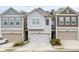 Charming townhome featuring a one-car garage and neutral siding at 6179 Centennial Run, Atlanta, GA 30349