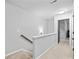 Upstairs hallway with carpet flooring and a view of the stairs and a bedroom entrance at 6179 Centennial Run, Atlanta, GA 30349