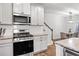 Well-equipped kitchen with stainless steel appliances, granite countertops, and white cabinets at 6179 Centennial Run, Atlanta, GA 30349