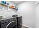 Laundry room featuring black front-loading Samsung washer and dryer at 6179 Centennial Run, Atlanta, GA 30349
