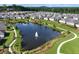 Aerial view of a community with a central pond, walking trails, and green spaces, surrounded by homes at 7 Hickory Branch, Hiram, GA 30141