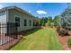 Landscaped backyard with manicured lawn, privacy fence and covered patio at 7 Hickory Branch, Hiram, GA 30141