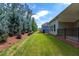 Spacious backyard with lawn, mature blue spruce trees and fence at 7 Hickory Branch, Hiram, GA 30141