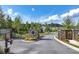 Community entrance with stone pillars, landscaping, and well-maintained roadways at 7 Hickory Branch, Hiram, GA 30141